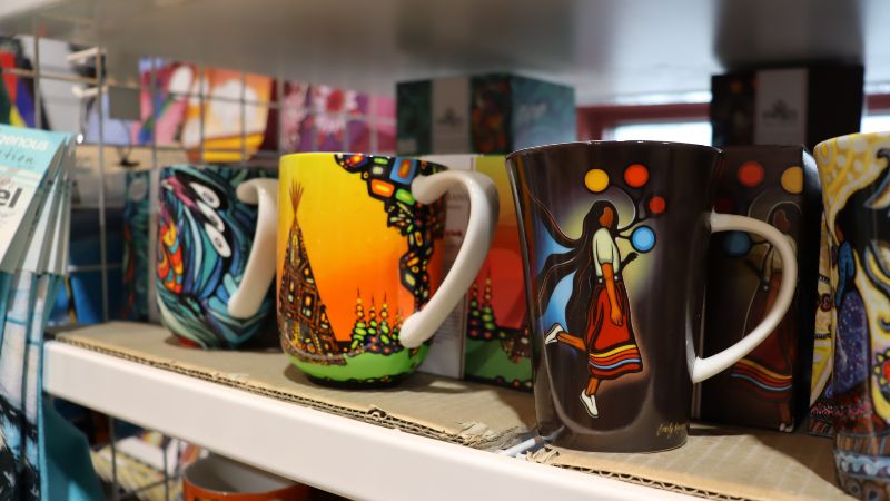 Colourful mugs with Indigenous art on them. 